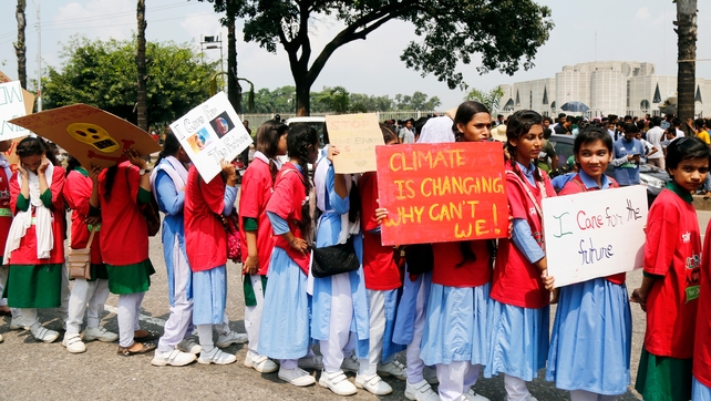 Bangladeshi school and college students hold placards during the global climate change strike in Dhaka