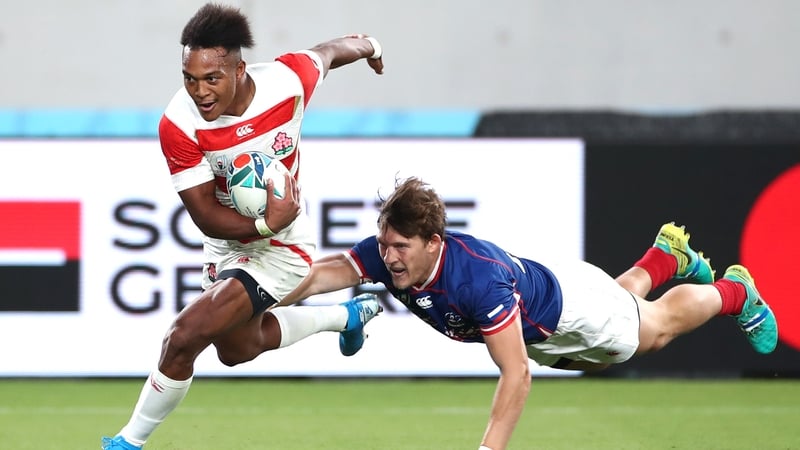 Kotaro Matsushima (L) breaks away to score Japan's fourth try