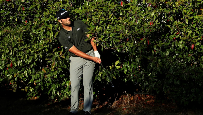 Jon Rahm plays his third shot on the 18th hole