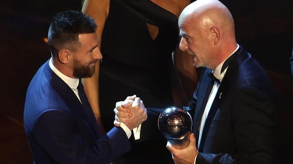 Gianni Infantino presents Lionel Messi with his award at La Scala in Milan
