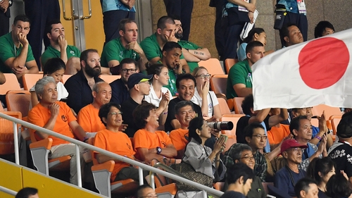 Members of the Ireland squad look on