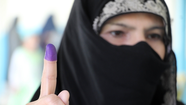 After casting their vote, many Afghans held up their fingers stained in indelible ink to show they had cast a ballot