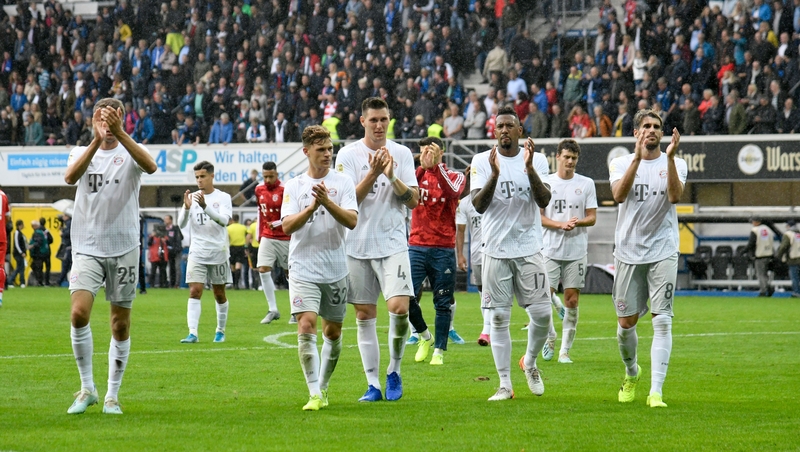 Bayern players applaud their fans after the win