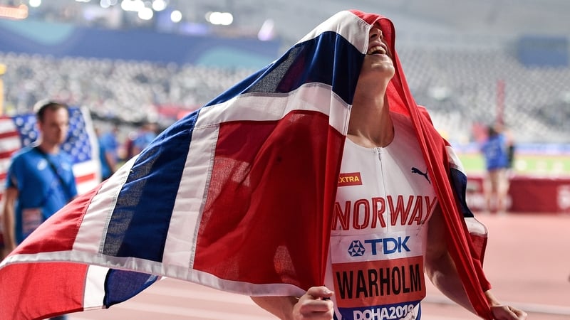 Karsten Warholm celebrates with the Norwegian flag