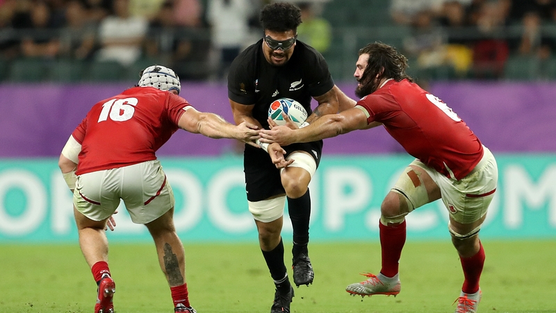 New Zealand's Ardie Savea (C) is tackled by Canada's Andrew Quattrin (L) and Lucas Rumball