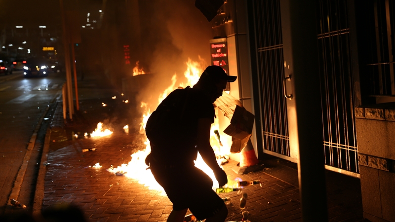 A protester throws petrol bombs at New Territories South Regional Police Headquarters in Tsuen Wan in Hong Kong