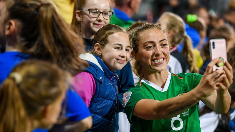 Megan Connolly of the Republic of Ireland takes a selfie for a young fan after the win over Montenegro
