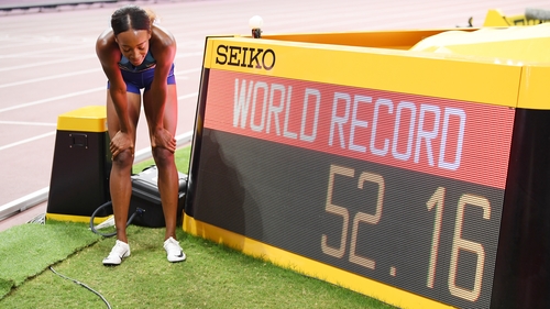 Muhammad stands beside the clock showing her new world mark