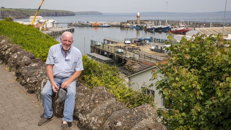 David Harris, owner of the Bay Café, Dunmore East, Co Waterford in Paul Kelly's work. David was photographed as a young boy for the iconic John Hinde series of postcards. (See original picture on this page)