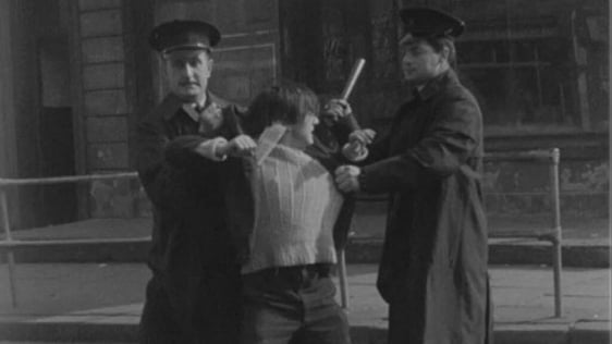 Protestor is restrained by RUC officers, Divis Street, Belfast (1964)