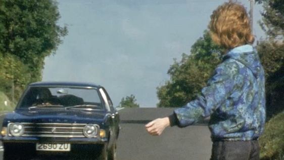 Housewife and Factory Worker Elisabeth Donaghy hitches a lift to work.