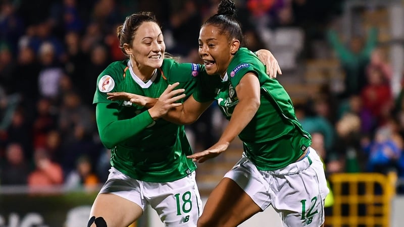 Jarrett celebrates her goal with Megan Campbell