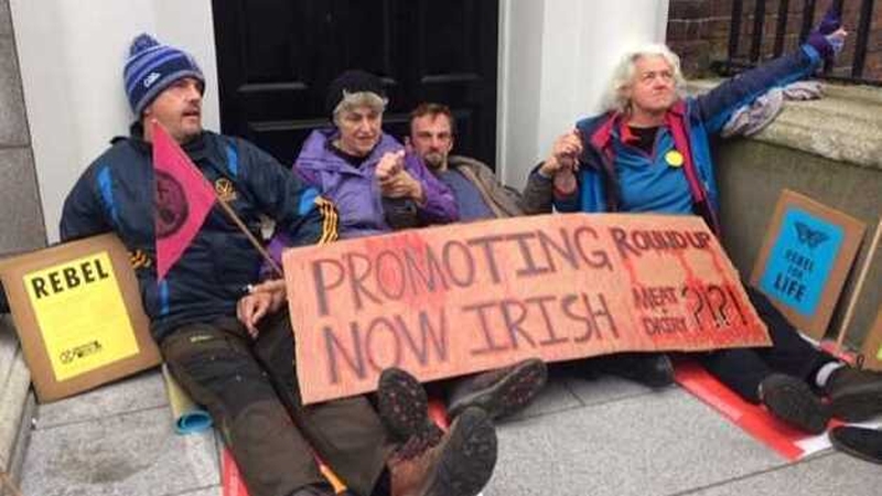Four Extinction Rebellion members have glued themselves to an office entrance in Ely Place