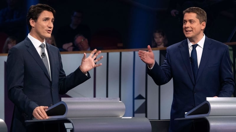 Canadian PM Justin Trudeau (L) and Conservative leader Andrew Scheer take part in the leaders French language debate