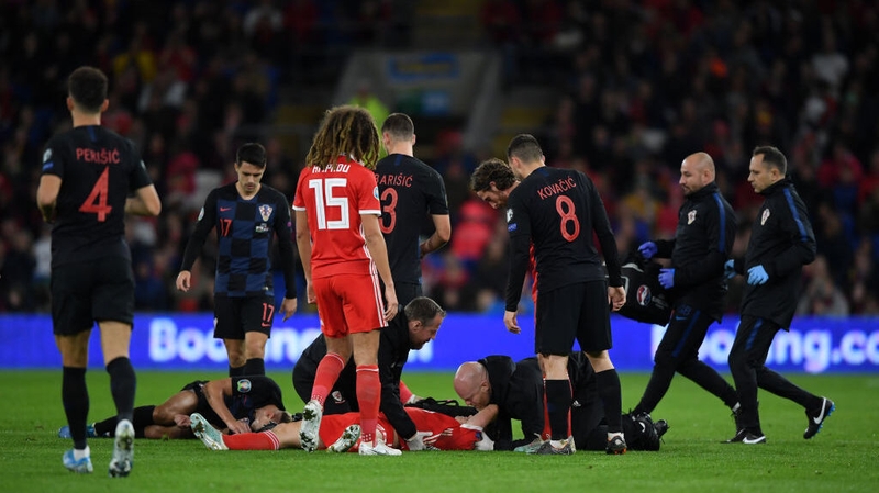 Daniel James receives medical attention after an aerial clash with Croatian defender Domagoj Vida