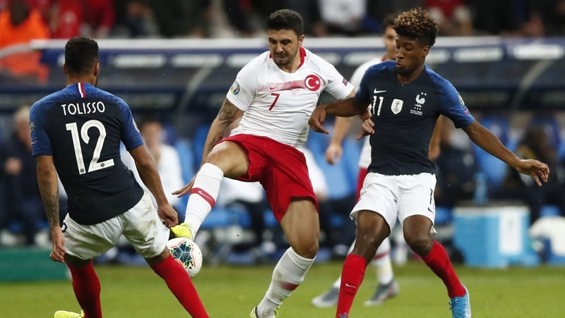 Corentin Tolisso (l) battles with Ozan Tufan