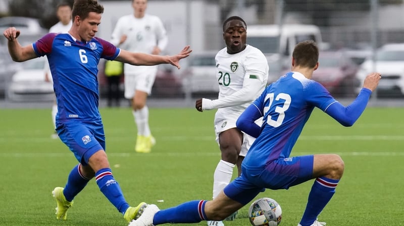 Michael Obafemi takes on Alex Hauksson (L) and Ari Leifsson