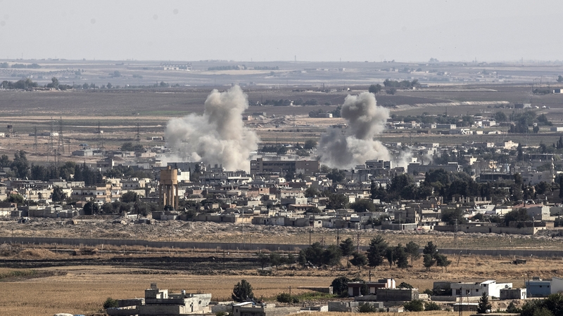 A picture taken from Turkish territory shows smoke rising from targets inside Syria during bombardment by Turkish forces at Ras al-Ein
