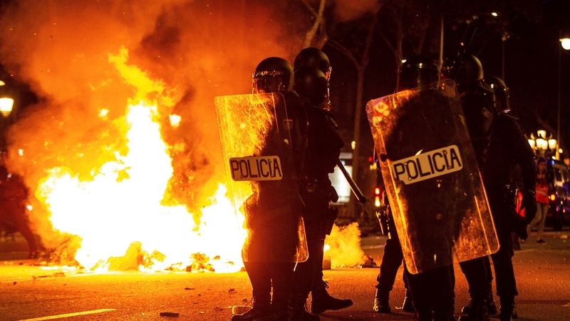 Some protesters threw cans and flares at riot police, setting fire to cardboard and other rubbish in some places