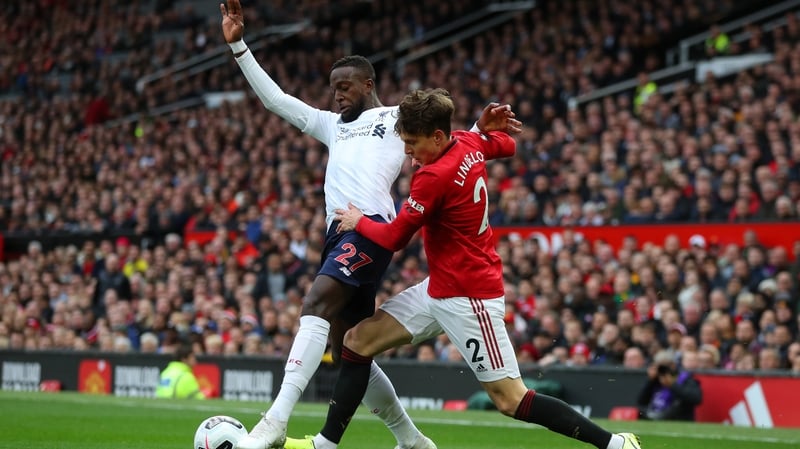 Victor Lindelof of Manchester United challenges Liverpool's Divock Origi at Old Trafford