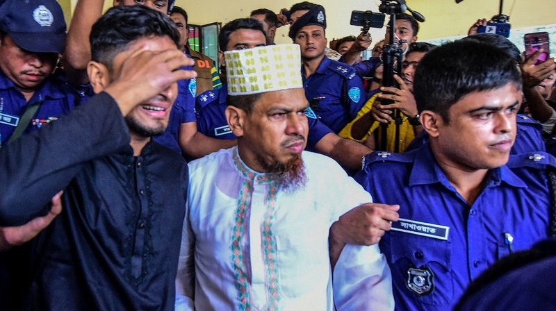 School headmaster and main suspect Siraj Ud Doula (centre) is escorted as he leaves the court following the verdict