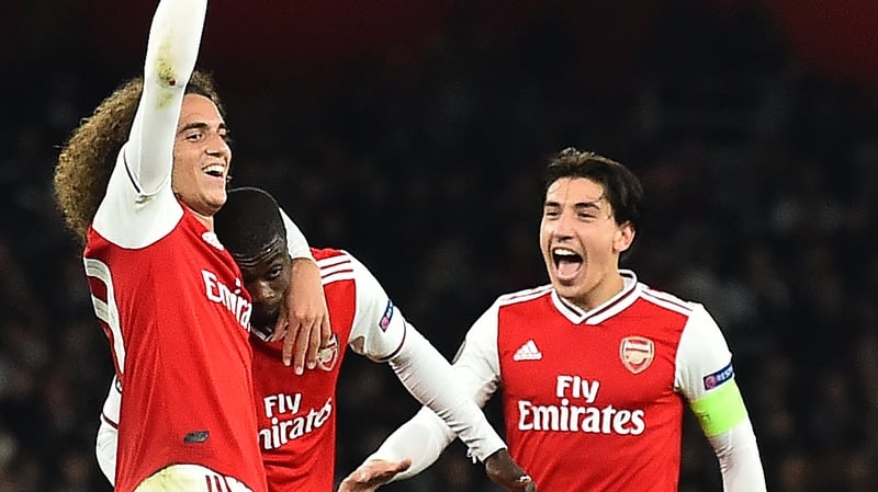 Nicolas Pepe (C) celebrates scoring his team's third goal with Matteo Guendouzi (L) and Hector Bellerin