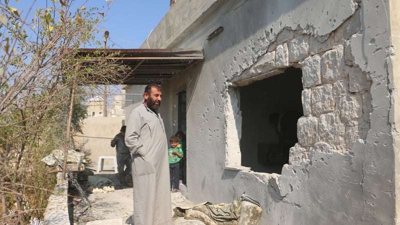 Villagers survey the scene in Barisha after the deadly US raid