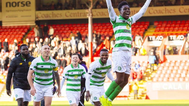 Jeremie Frimpong celebrates with the Celtic fans following the game