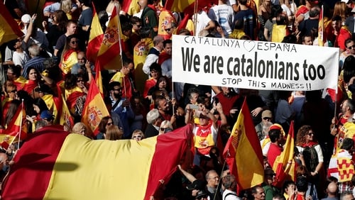 Around 80,000 people, according to a police estimate, marched down Barcelona's central Gracia thoroughfare waving Spanish and Catalan flags