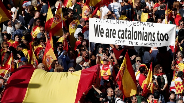 Around 80,000 people, according to a police estimate, marched down Barcelona's central Gracia thoroughfare waving Spanish and Catalan flags