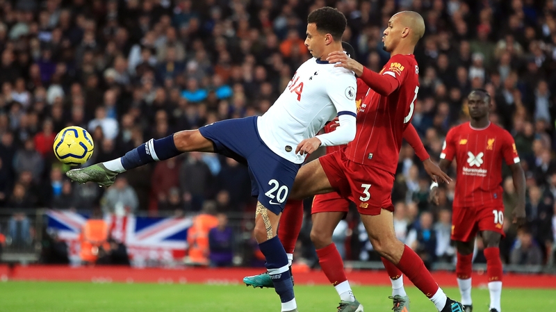 Dele Alli is tackled by Liverpool's Fabinho