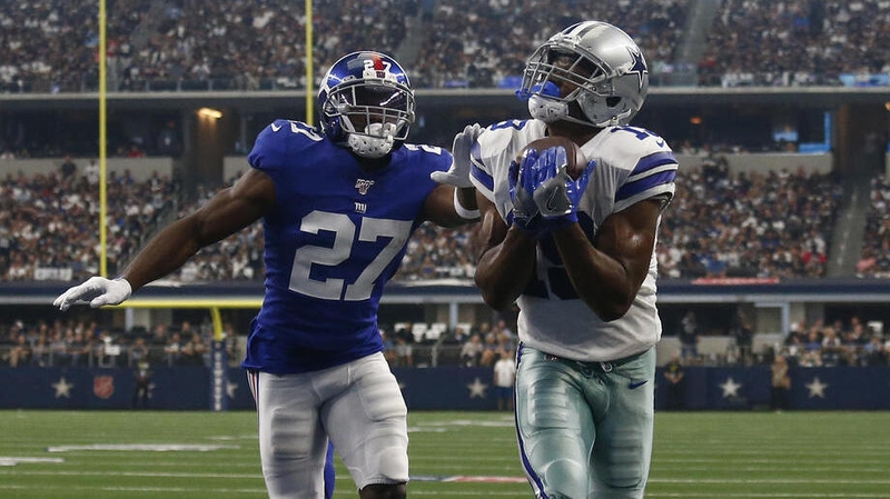 Dallas Cowboys player Amari Cooper (R) catches the ball for a touchdown