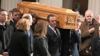 Gay Byrne's coffin is carried into Dublin's Pro Cathedral