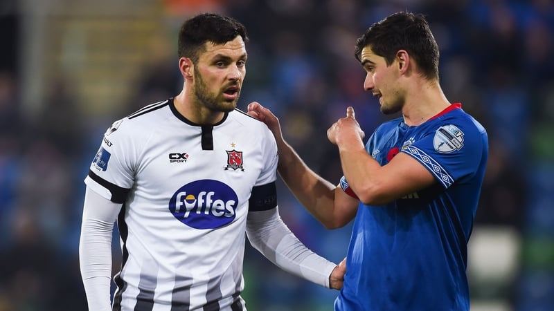 Dundlak's Pat Hoban exchanges views with Jimmy Callacher of Linfield