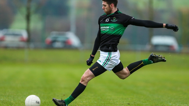 Luke Connolly of Nemo Rangers kicks a free
