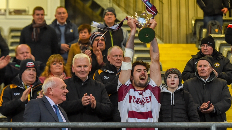 Christopher McKaigue raises the Four Seasons Cup aloft