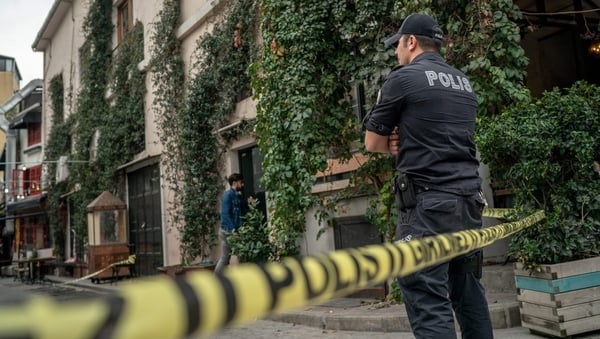 A Turkish police officer stands guard outside the home and office of James Le Mesurier in Istanbul