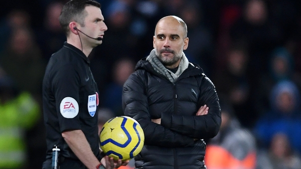 Pep Guardiola (R) with referee Michael Oliver
