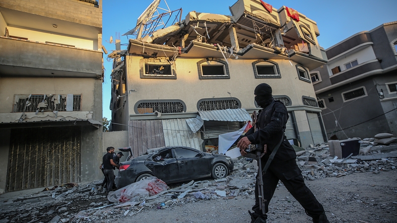 Islamic Jihad inspect the damaged house of leader Bahaa Abu al-Ata after an Israeli air strike in Gaza City