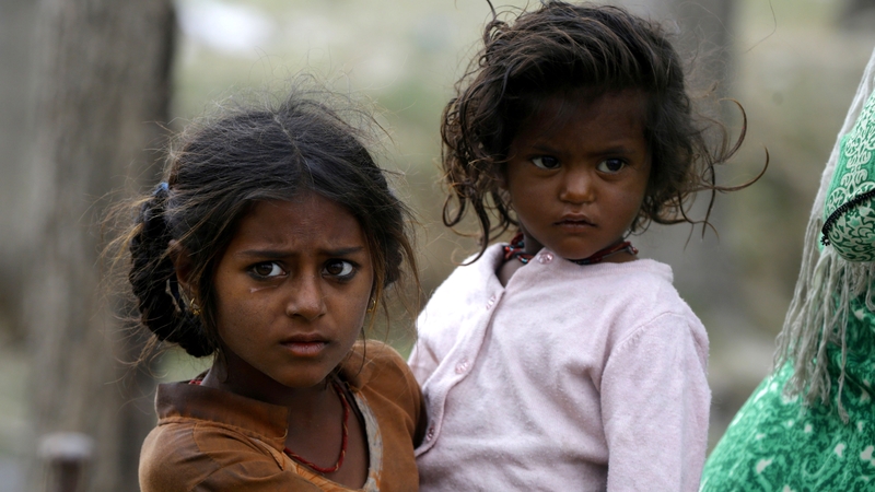 A young girl carries a child in Indian Kashmir (file image)