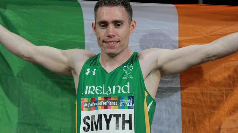 Jason Smyth hold the tricolour aloft in Dubai