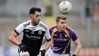 Ryan Johnston of Kilcoo in action against Jack Love of Derrygonnelly