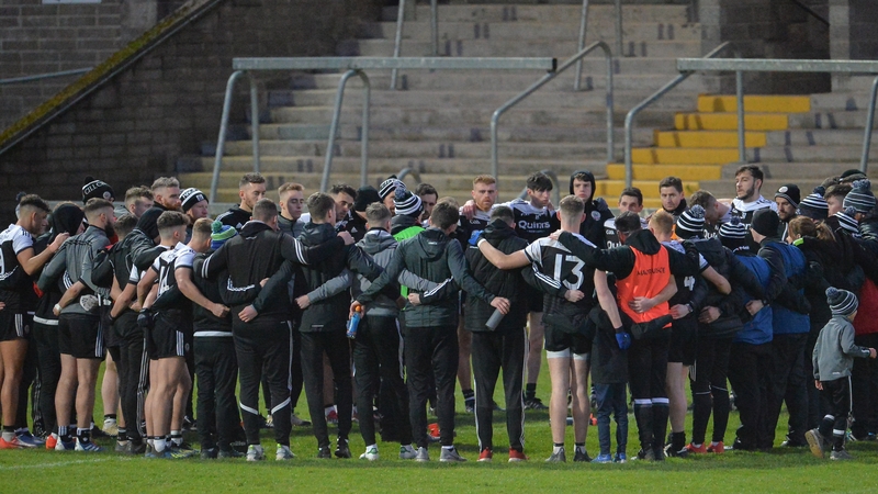 Kilcoo players huddle together after their win against Derrygonnelly