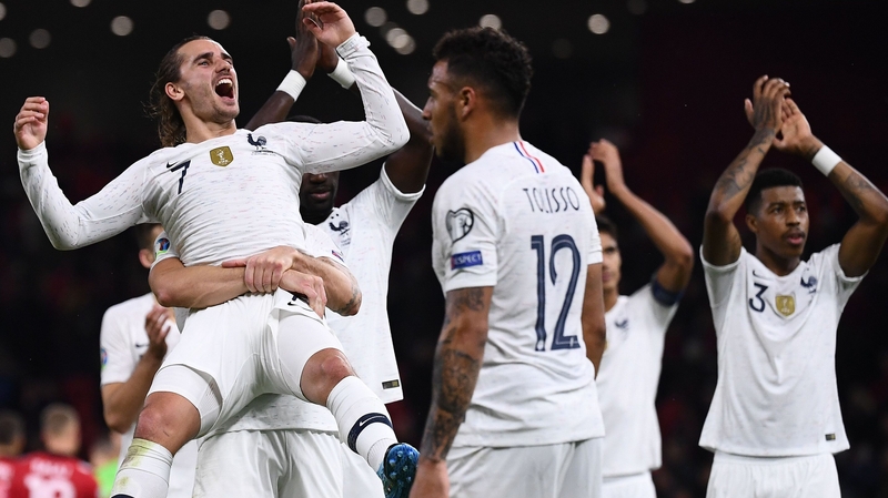 Antoine Griezmann (L) is hoisted into the air after helping France to victory