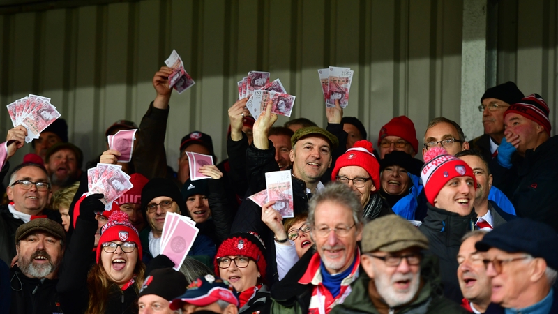 Gloucester fans wave fake money during their recent Premiership meeting with Saracens