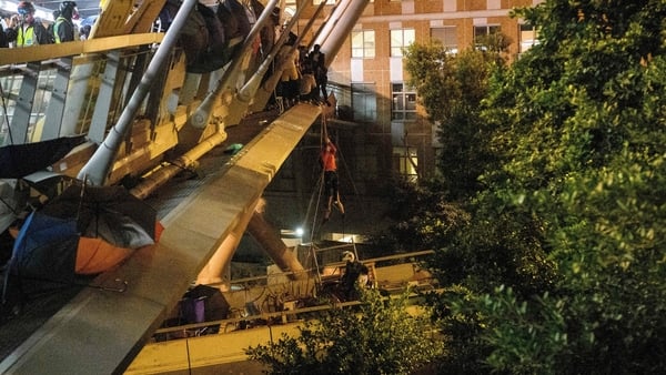 Some protesters climbed down a rope from a bridge to awaiting motorbikes