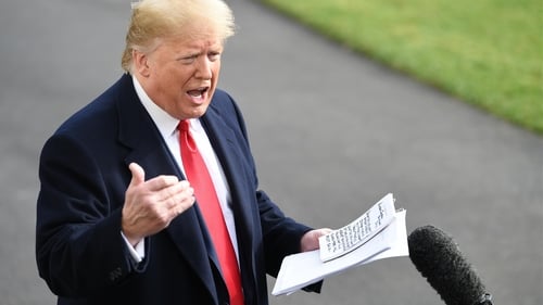 US President Donald Trump pictured holding his notes yesterday
