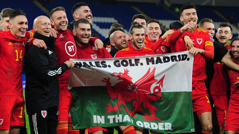 Gareth Bale and his Wales team-mate celebrate with the flag