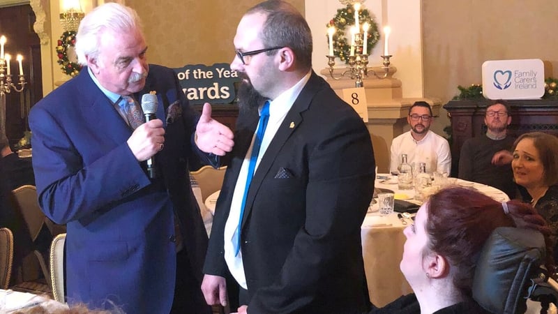 Marcin Filak and his wife Ola with Marty Whelan at the Carer of the Year ceremony