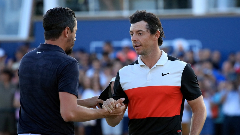 Rory McIlroy shakes hands with his playing partner Mike Lorenzo-Vera of France